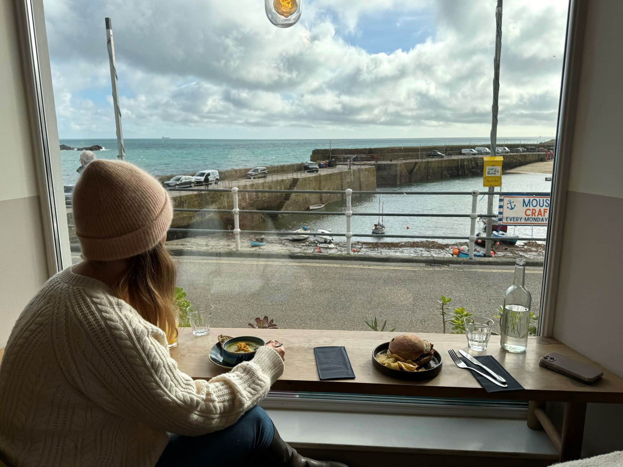 Woman sitting in the window of a cafe 