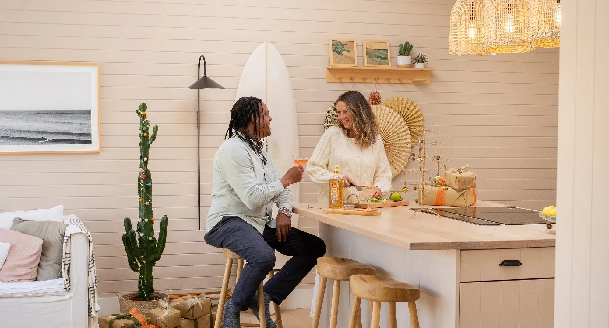 A couple enjoying festive cocktails in a kitchen