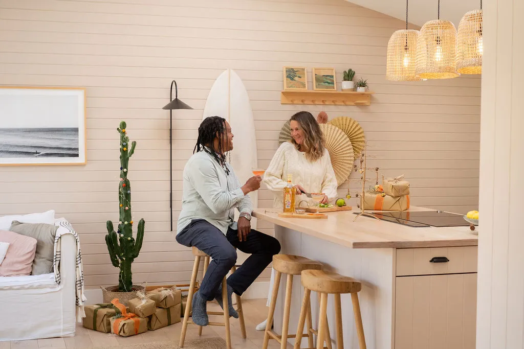 A man and woman enjoying a cocktail in a stylish property